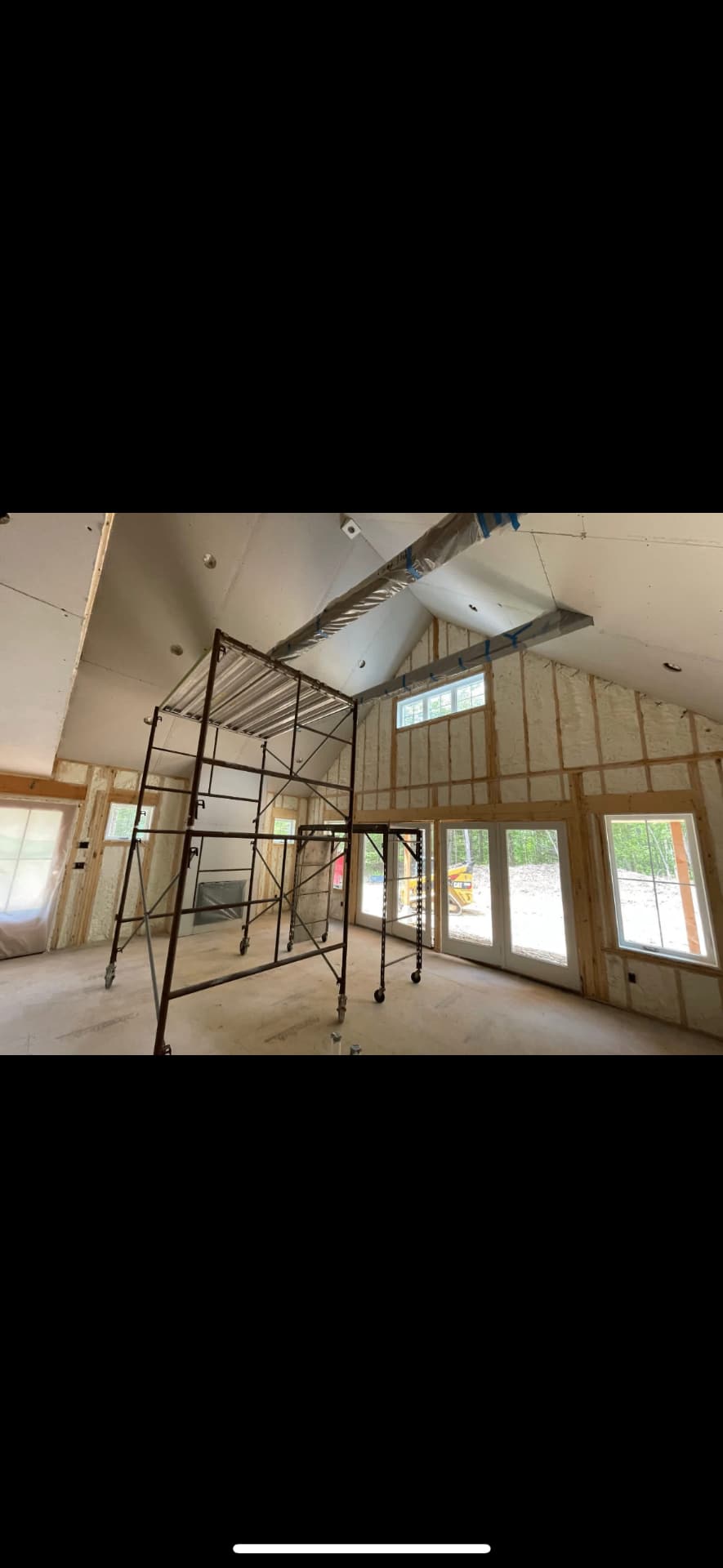 New construction interior with staging and framed ceiling