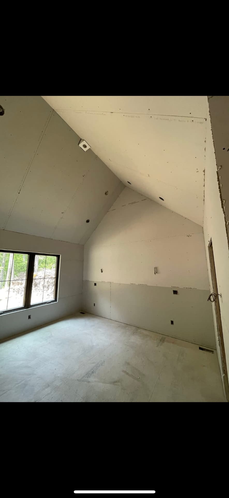 Sloped attic ceiling drywall taped and skim coated