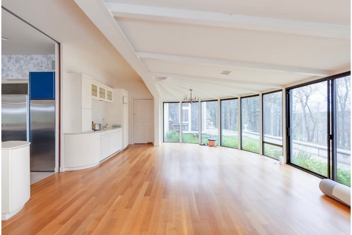 Bright open room with hardwood floors after painting