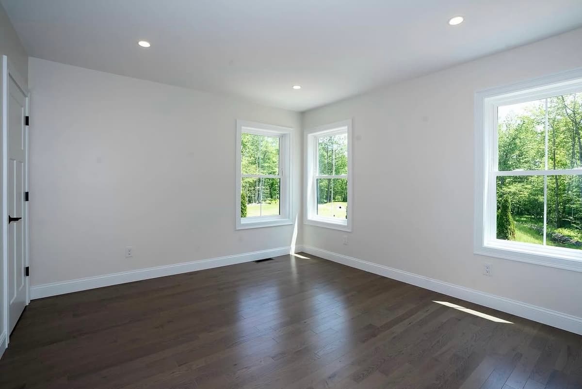 Bedroom with dark hardwood floors after painting