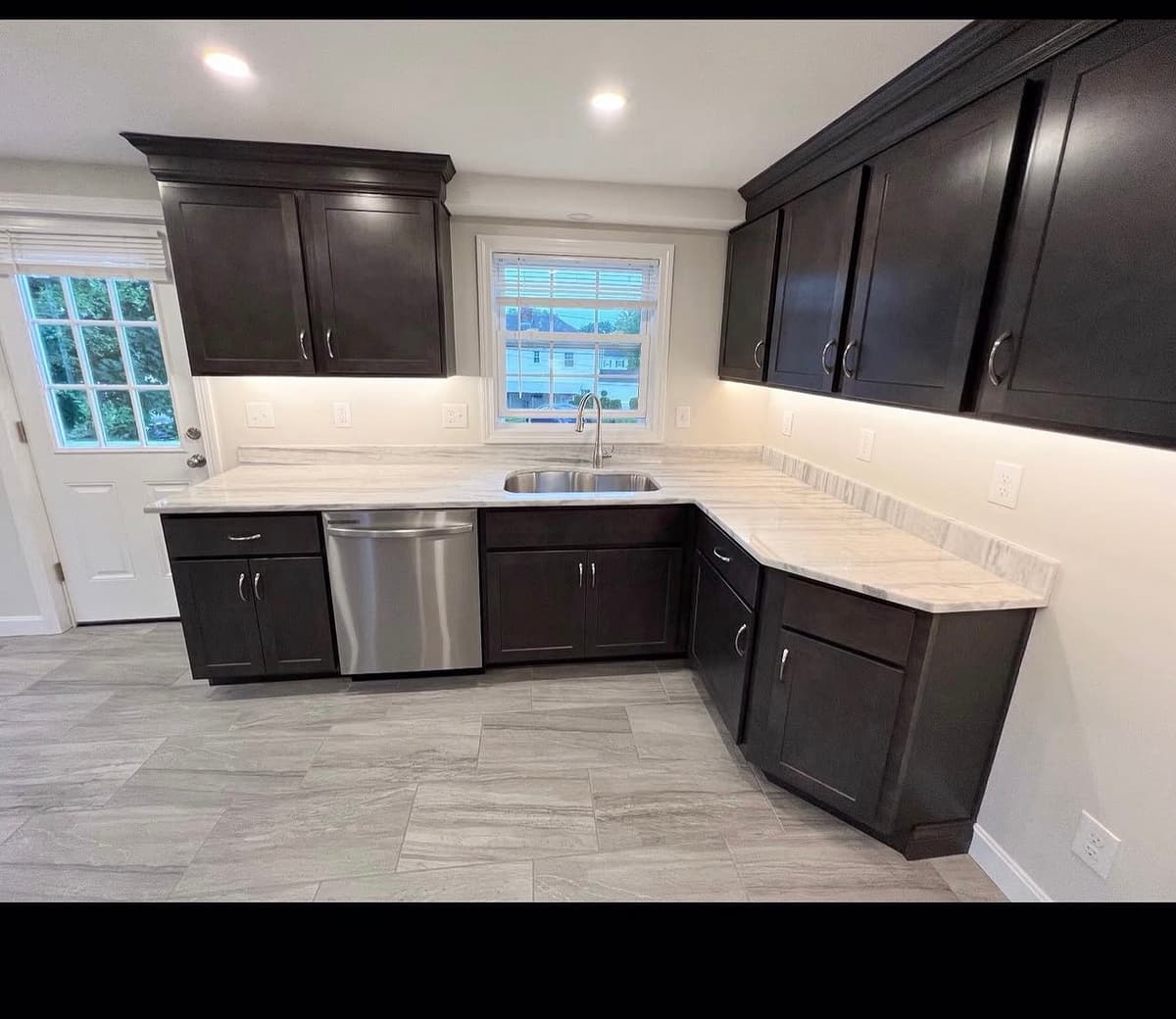 Kitchen with dark cabinets after interior painting in Milton, NH